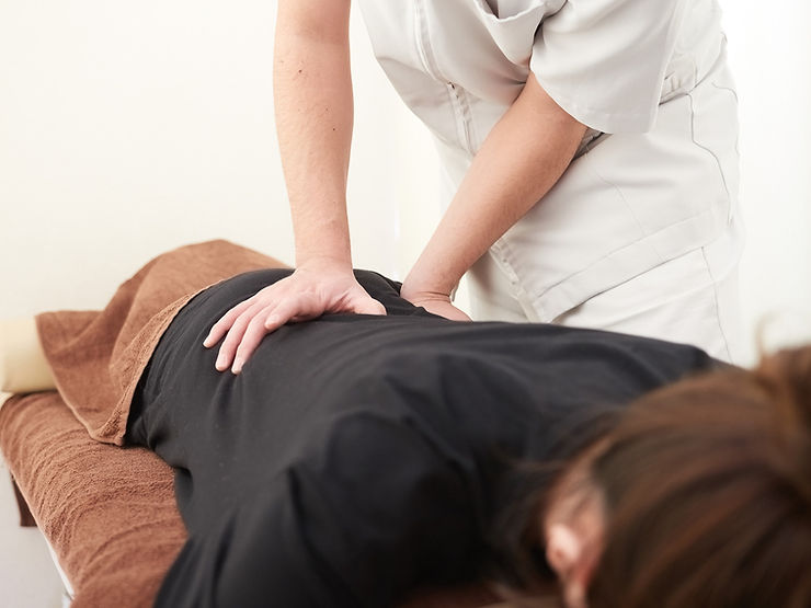 The image displays an therapist applying Manual Therapy on a patient