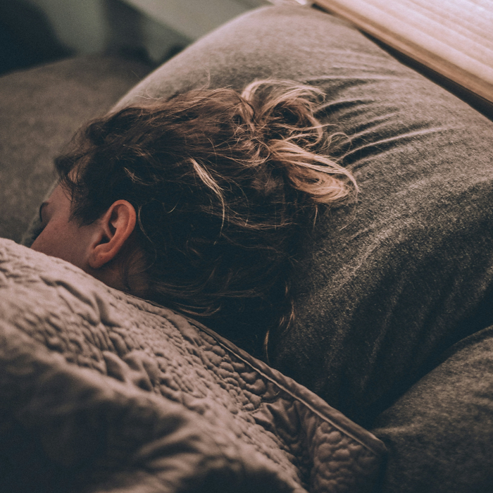 A woman sleeping in her bed