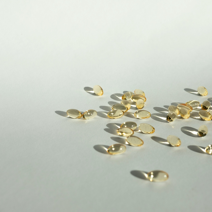 Pills and supplements lying on flat surface.